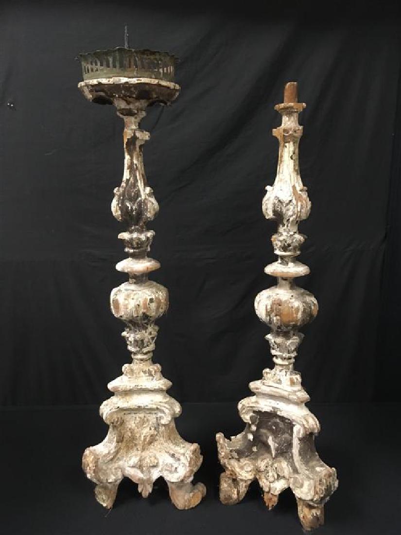 TWO 18TH C ITALIAN ALTAR CANDLESTICKS: Two 18th century Italian Altar candlesticks,one meaasures 36" tall to spike, the other has lost the top and measures 32.5" tall. Condition: heavy signs of age, wormage to wood, splits to wood, losses 