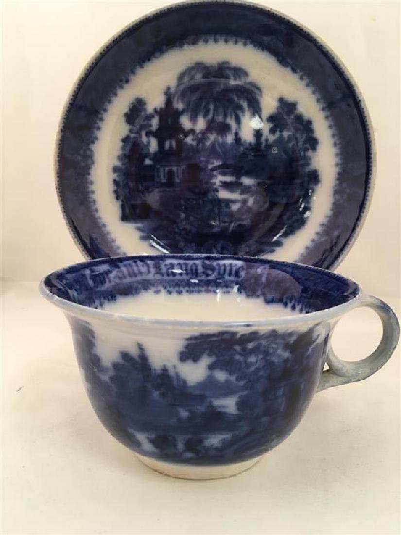 HUGE AULD LANG SYNE FLOW BLUE CUP & SAUCER: RARE HUGE AULD LANG SYNE FLOW BLUE CUP & SAUCER: Cup with "For Auld Lang Syne" around inner rim, cup and saucer with Orientalist style garden scene. Cup measures 7" rim to handle and just under 3.5" t