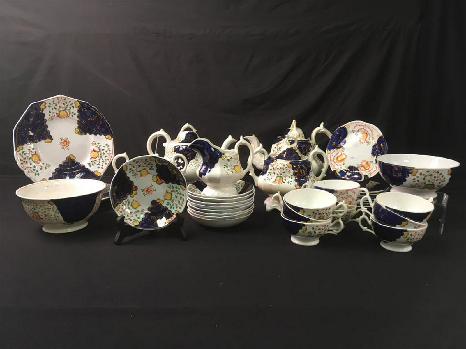SET ANTIQUE GAUDY WELSH PORCELAIN DINNERWARE: Set of antique Gaudy Welsh porcelain dinnerware. Includes (8) 6" plates, (9) 5.5" low bowls, (2) 6.25" footed bowls (one with hairline), (2) 7.5" (handle to handle) sugar bowls (one without lid), (2) 