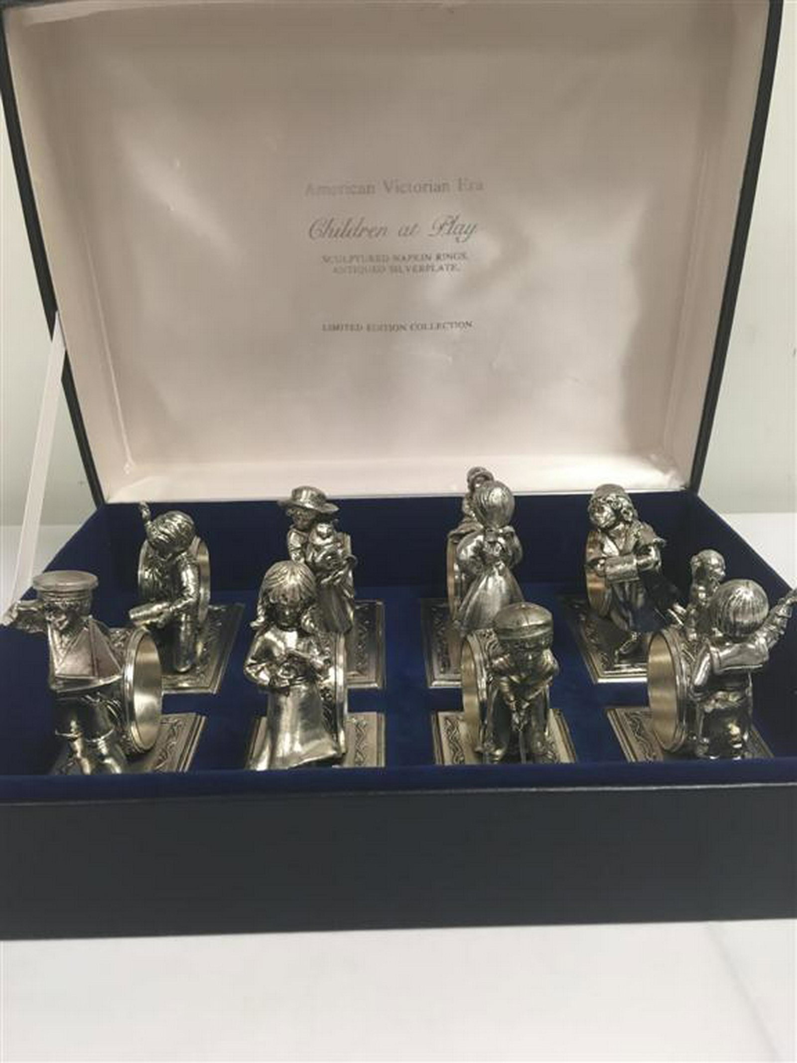 LANCE SILVER PLATED NAPKIN RINGS: CHILDREN AT PLAY: Vintage Lance 1979 silver plated cast metal napkin rings. "American Victorian Era: Children at Play", Limited Edition. Set of eight. Condition: good, includes original box, like new, see images. Each 