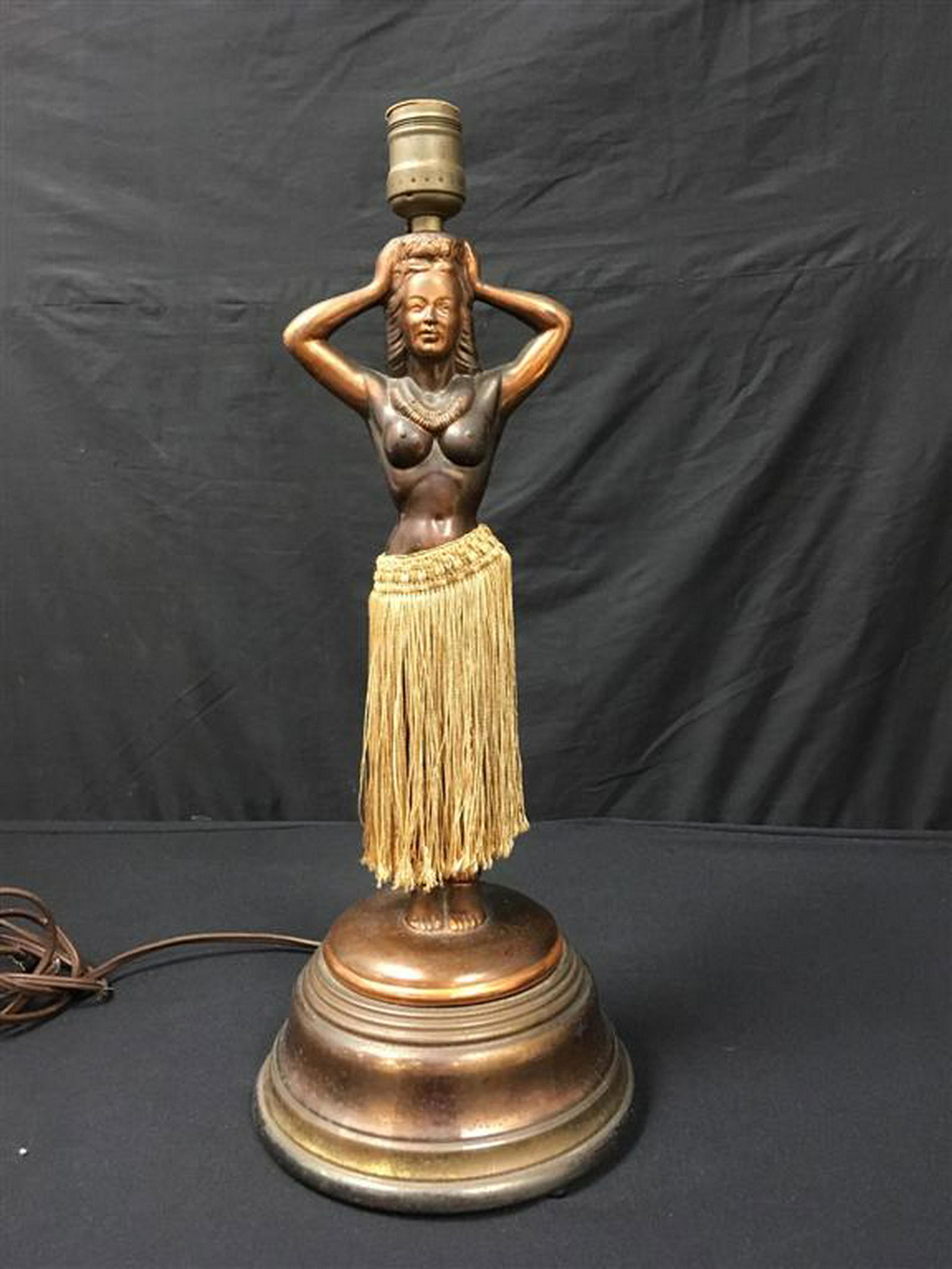 RARE VINTAGE DODGE INC HULA GIRL DANCING LAMP: Rare and vintage Dodge Inc. dancing Hula girl lamp. Copper finish (worn in areas). Original skirt. Signed on base. Condition: UNTESTED, NEEDS RE-WIRING, wear to copper finish, very fine cracks to roun