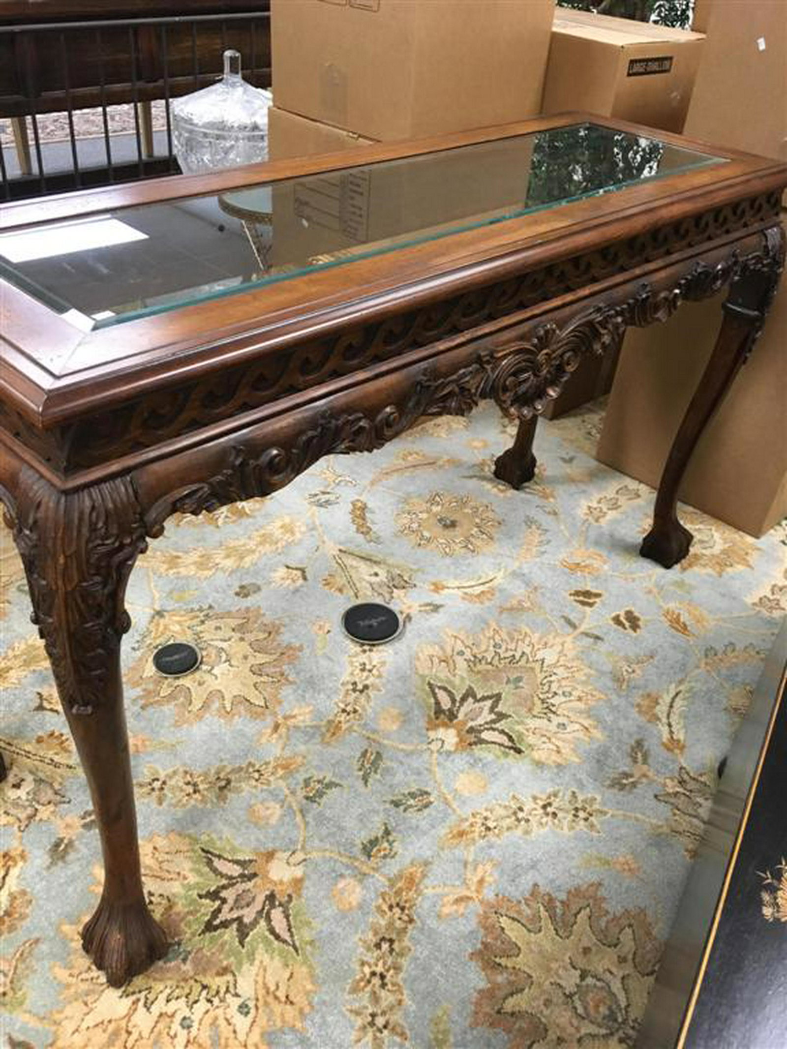 HEAVILY CARVED WOOD AND GLASS CONSOLE TABLE: A wood carved console or sofa table with beveled glass insert. Measures: 56" x 20" deep x 34" tall. Condition:: good.