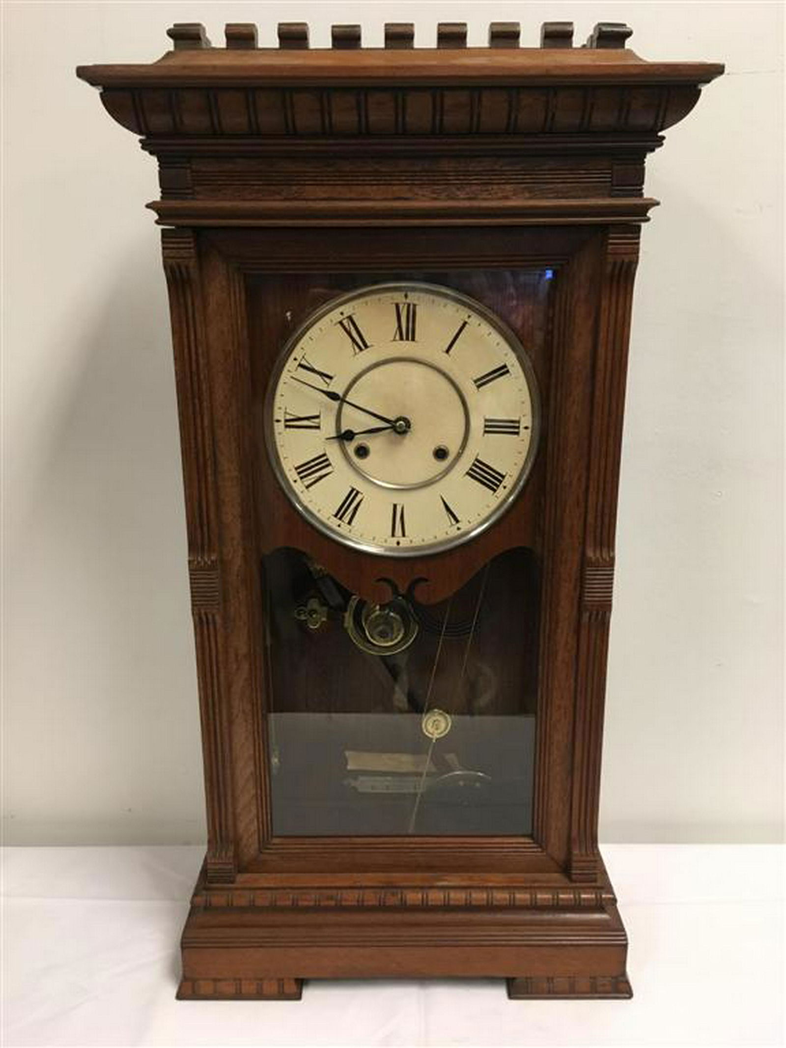 SETH THOMAS GARFIELD CLOCK: Seth Thomas Garfield model Clock, 8 day time and strike brass movement stamped "ST" and Seth Thomas, Thomaston CT. Original brass damascene pendulum, original metal dial (repainted), Case with wear to