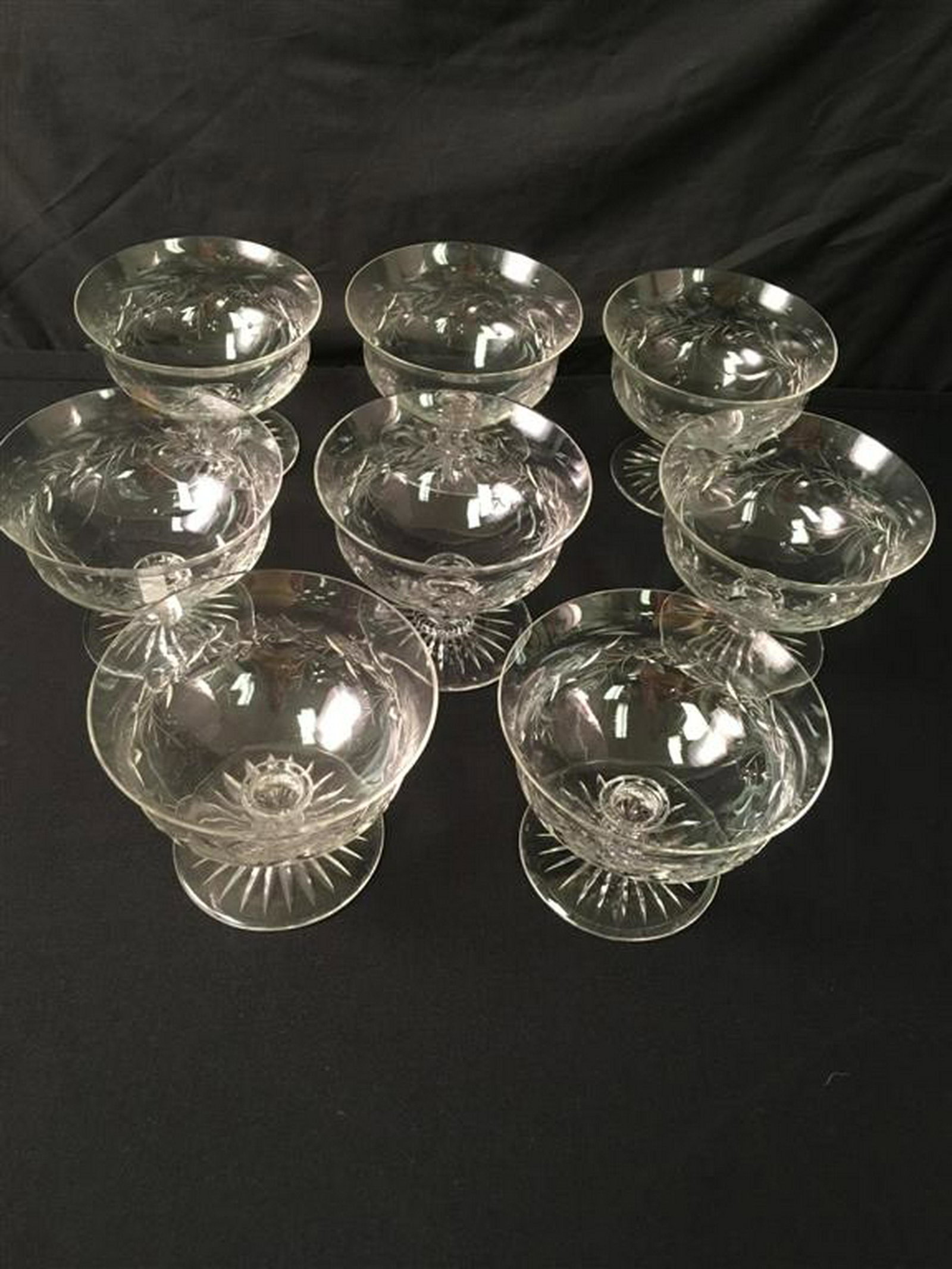 EIGHT CUT CRYSTAL FOOTED BOWLS: A set of eight antique crystal bowls. Believed to be Pairpoint. Each measures 5.5" wide x 4.5" tall. Condition: good. Two bowls each with with 1 tiny rim chip.