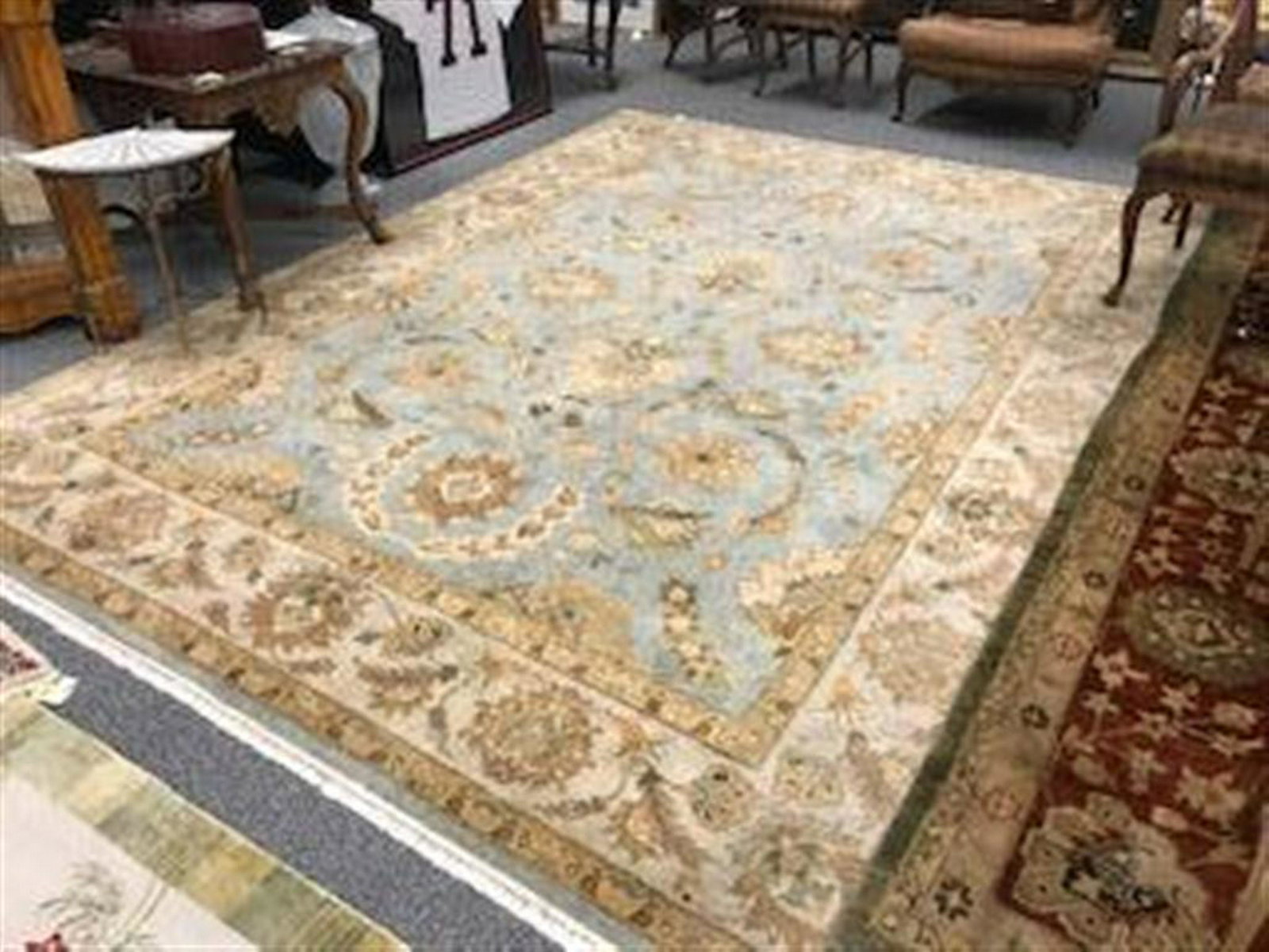 LARGE INDIAN HAND KNOTTED WOOL RUG - 8'10" X 11'9": Large Indian hand knotted wool rug measuring 8'10" x 11'9". Floral pattern over light blue ground. Condition: good, may show minor signs of normal age, see images. Weight: approx. 75 lbs.