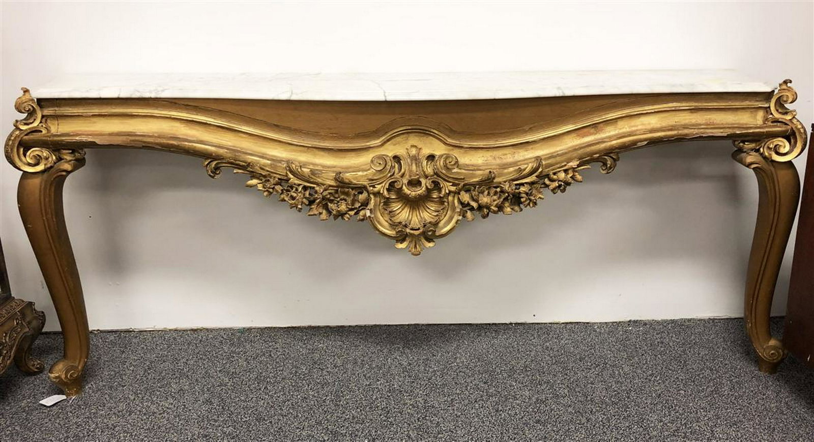 LARGE EARLY 19TH C ITALIAN GILT CONSOLE TABLE: LARGE EARLY 19TH C ITALIAN GILT MARBLE TOPPED CONSOLE TABLE - newer white and grey variegated marble top, deep relief carvings of a shell and flowers. Measures: 82.5" long x 35" tall and 19" deep. Con