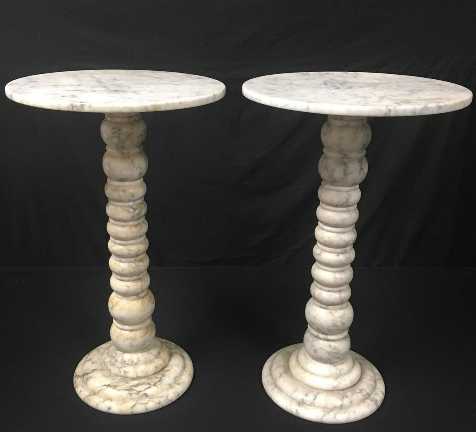 PAIR ITALIAN CARRERA MARBLE PEDESTAL SIDE TABLES: Pair Italian carrera marble pedestal side tables. Each one measures 19.25" tall x 11.75" diameter. Condition: one has been re-glued at one of the joints, minor signs of wear and age, some stains/disco