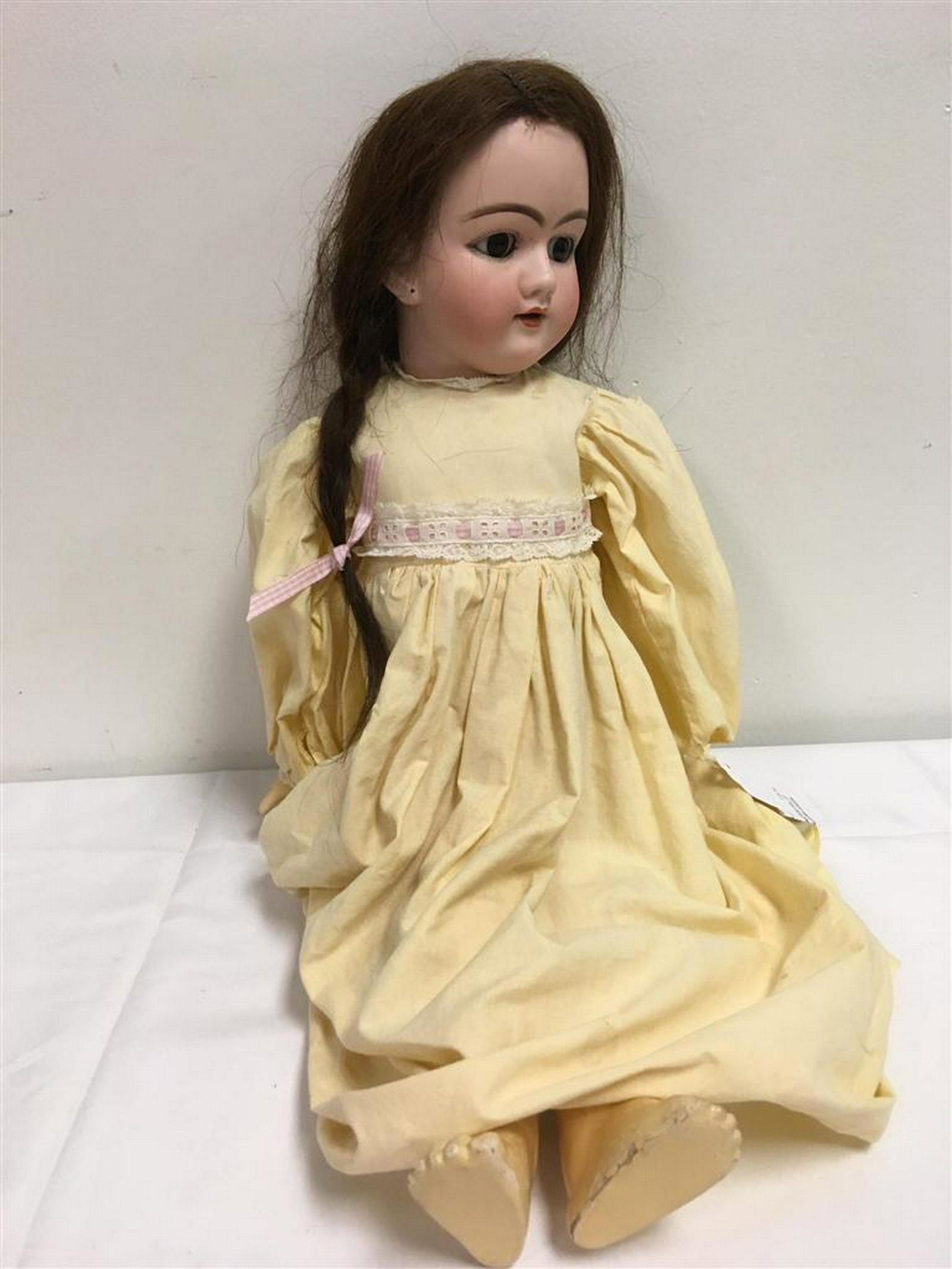 ANTIQUE GERMAN PORCELAIN HEAD DOLL 23": Antique (late 19th - Early 20th C) German porcelain head doll with composite body, composite articulated arms and legs, open brown eyes, open mouth, real hair wig, and pierced ears. Stamped on back of
