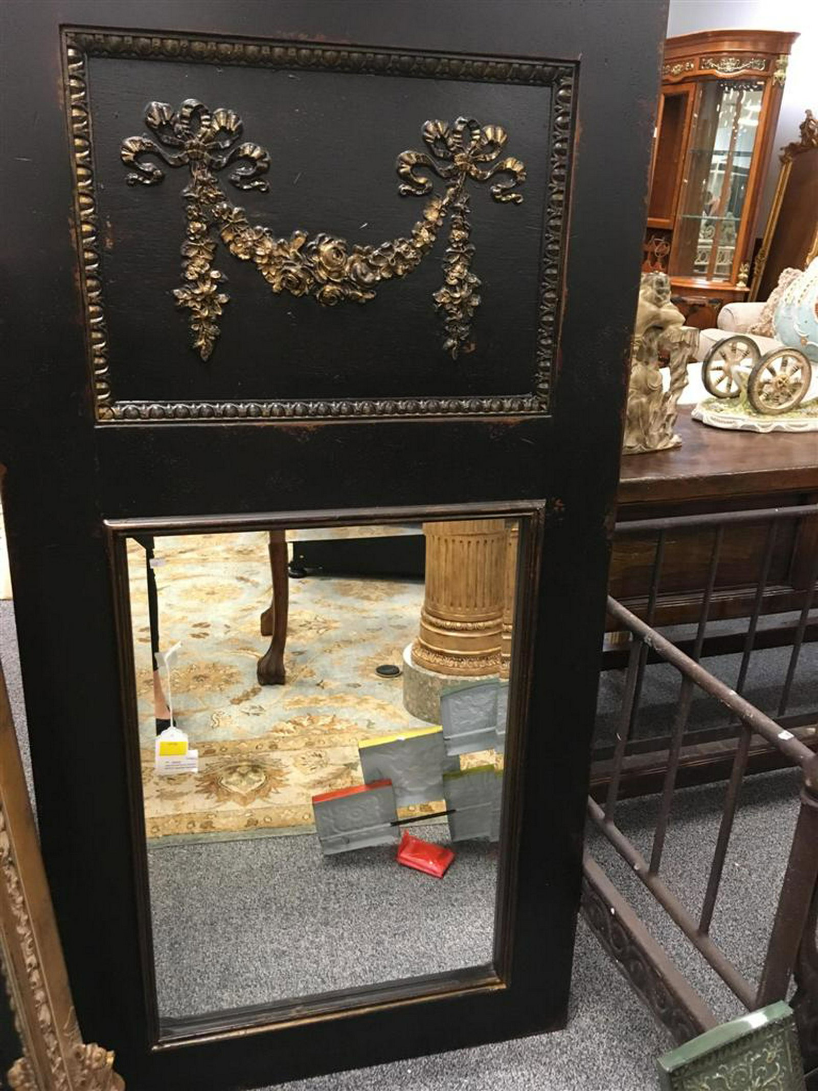 HABERSHAM BLACK PAINTED TRUMEAU STYLE MIRROR: Habersham black painted Trumeau-style mirror with hand carved ribbon and floral design, gold gilt highlights and beveled glass. Measures: 32" x 64" T x 1.5" deep.