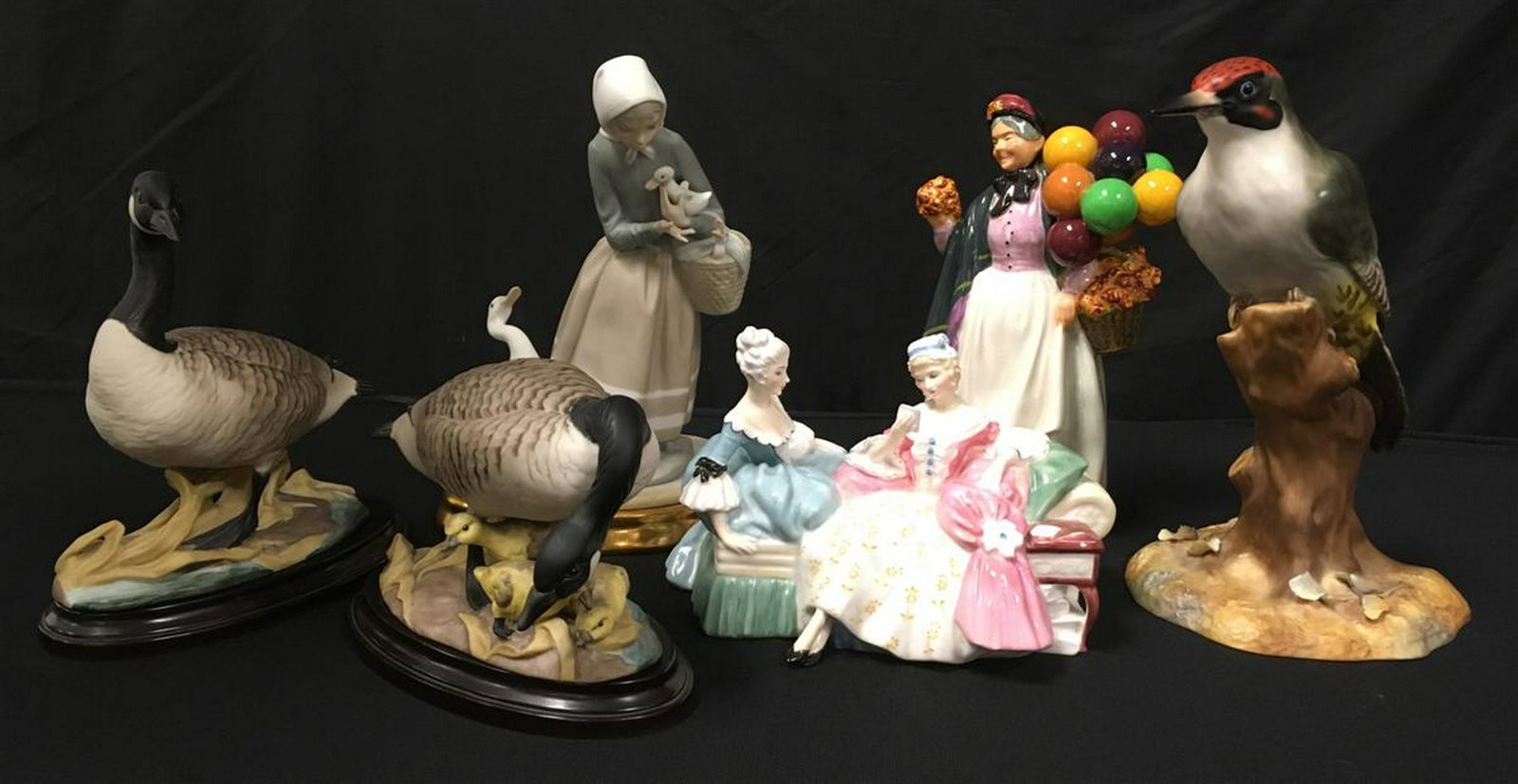 6 PORCELAIN FIGURINES: BOEHM, LLADRO, CROWN DERBY: Lot of 6 porcelain figurines. Includes two Boehm Canada Geese (408) with porcelain stands, a Royal Crown Derby 9.6" Woodpecker, Royal Doulton "Biddypennyfarthing", Royal Doulton "The Love Letter", and