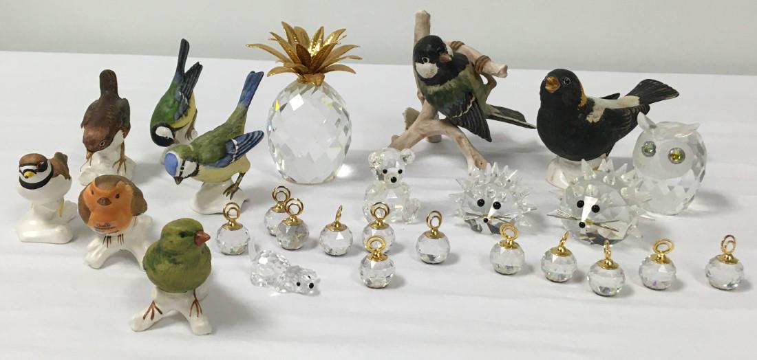 COLLECTOR'S DECORATIVE LOT: Collector's lot of assorted smalls: a vintage Nippon hat pin holder, five Swarovski animals, a Swarovski pineapple, twelve Swarovski place card holders, and eight Goebel porcelain birds. Swarovski pin