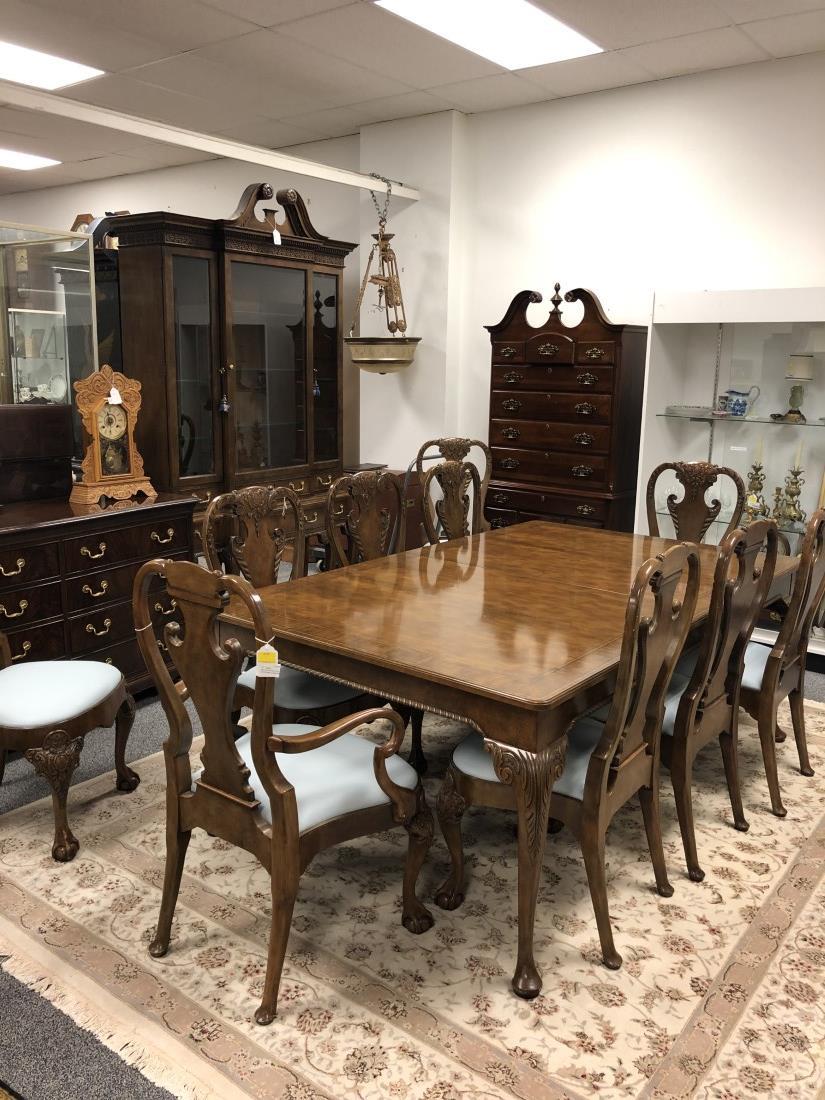 BAKER FURNITURE STATELY HOMES TABLE & 10 CHAIRS: Baker Furniture banded walnut dining dining table and 10 carved burled walnut dining chairs. The discontinued chairs are from Baker's Stately Home Collection and feature elaborate carved details, ball