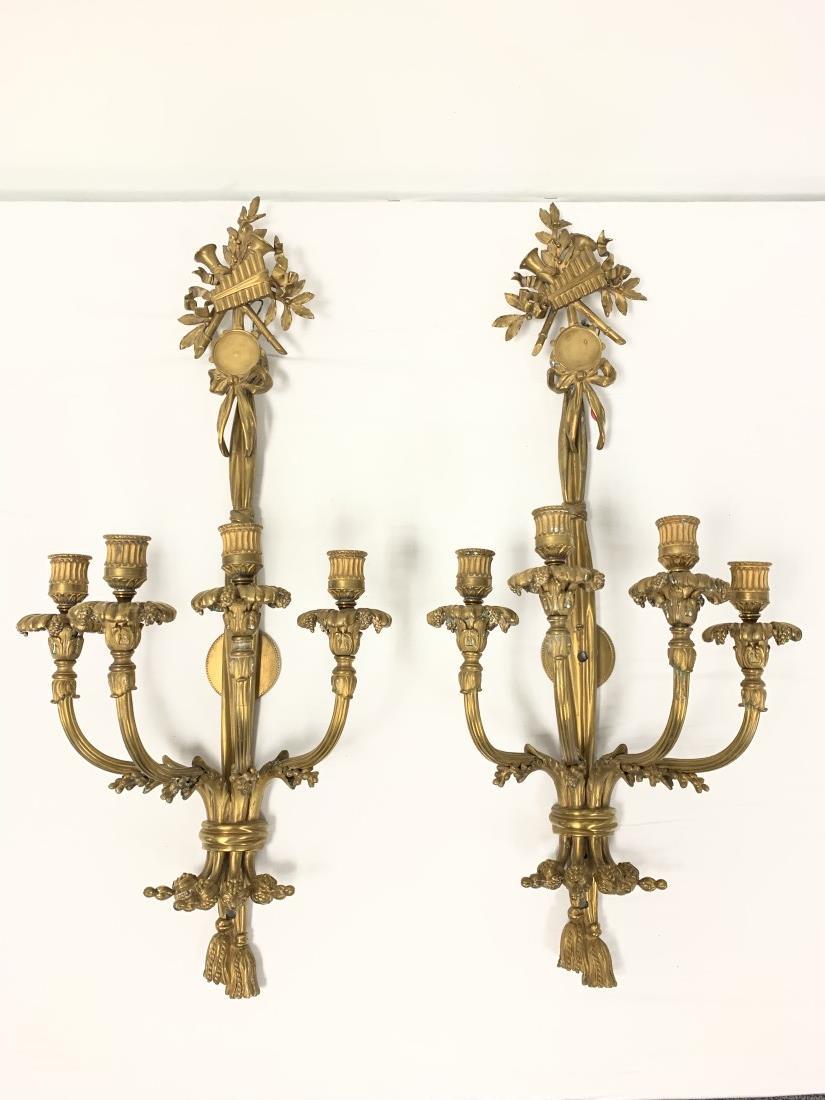 PAIR FRENCH NEO. LOUIS XVI GILT BRONZE 32" SCONCES: Pair of French Neoclassical Louis XVI gilt bronze wall sconces. Musical instrument motifs at the top with the traditional tassels below. Each one is stamped with a number on the front, near the center