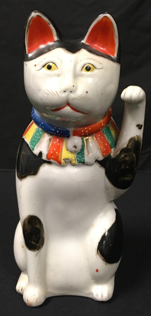JAPANESE MEIJI KUTANI PORCELAIN MANEKI NEKO CAT: Japanese Meiji Kutani porcelain Maneki Neko or beckoning cat (lucky cat). Late 19th/early 20th century. Unsigned. Condition: some crazing to glaze, minor signs of age and normal wear, no signs of repa