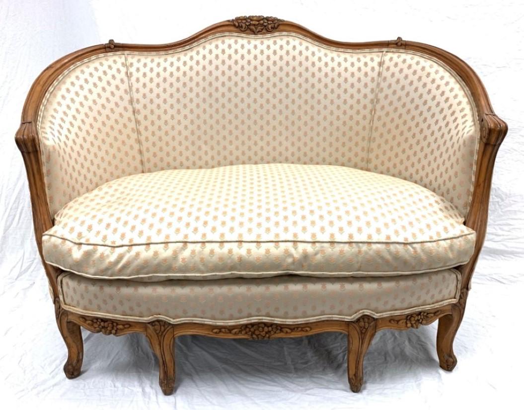 SMALL LOUIS XV STYLE CARVED WOOD SETTEE: Small Louis XV carved wood sette measuring 38" tall x 53" wide and 30" deep. All-over repeating pattern on an off-white ground. Condition: minor discoloration near edges of fabric, also under cushion,