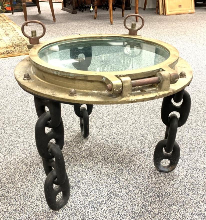 VINTAGE BRASS NAUTICAL SHIP'S PORTHOLE SIDE TABLE: Vintage heavy cast brass ship's porthole, converted to a side table. Three chain style cast iron legs. Condition: expected signs of age and use, see images. Measures 18.5" tall to table surface, or 21