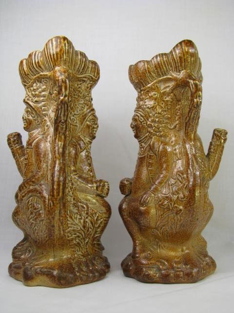 PAIR FIGURAL MAN w/ STEIN EARTHENWARE VASES: Pair of earthenware bud vases of a man sitting down holding a stein. Measures 6 1/4" high by 3" wide by 3" deep. Condition good.