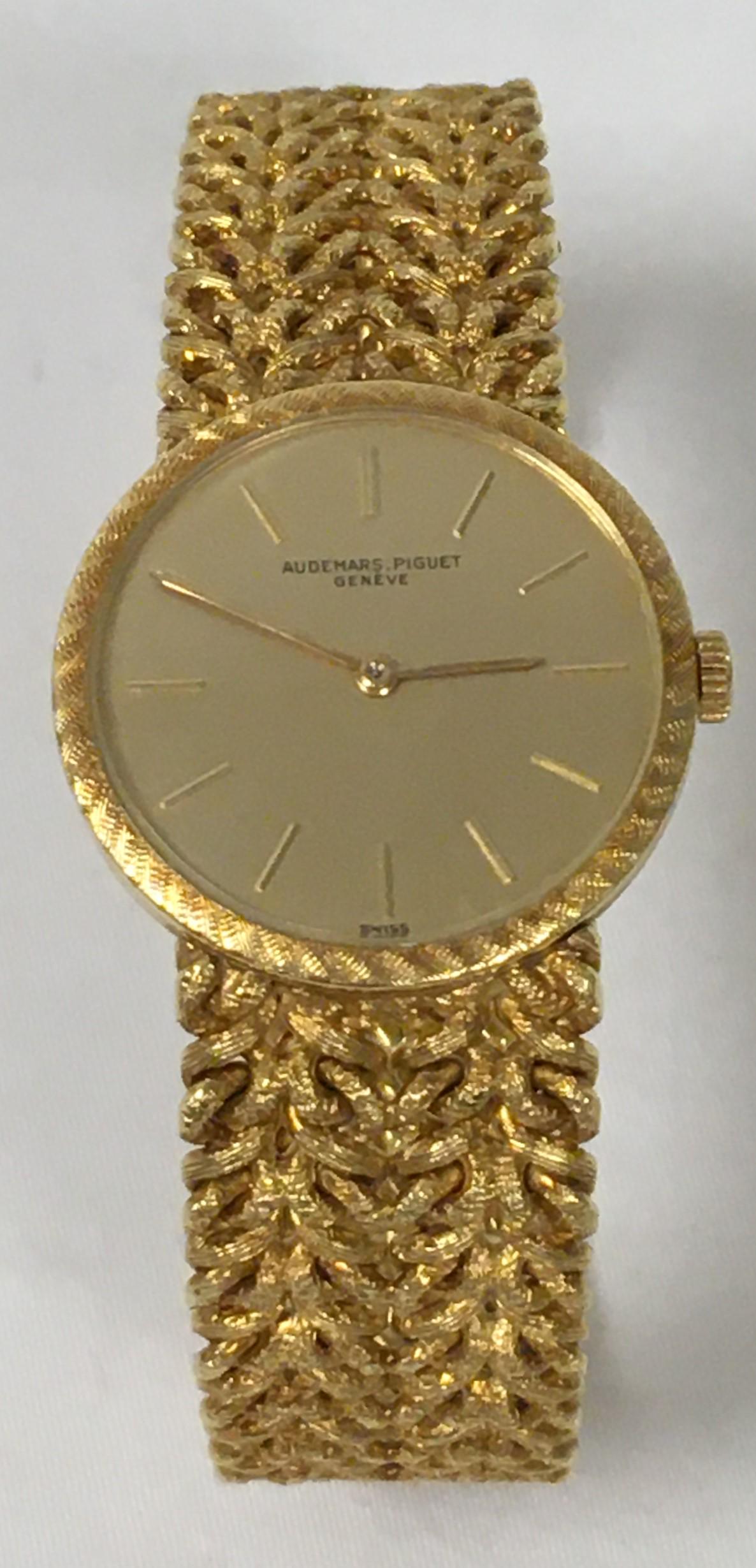 LADIES 18K YELLOW GOLD AUDEMARS PIGUET WATCH: Ladies 18k yellow gold Audemars Piget watch. Fancy link bracelet with a folding clasp. Marked "AP" above, and "18k 0.750" under clasp. Watch face measures 20mm across, case measures 23.5mm across, not