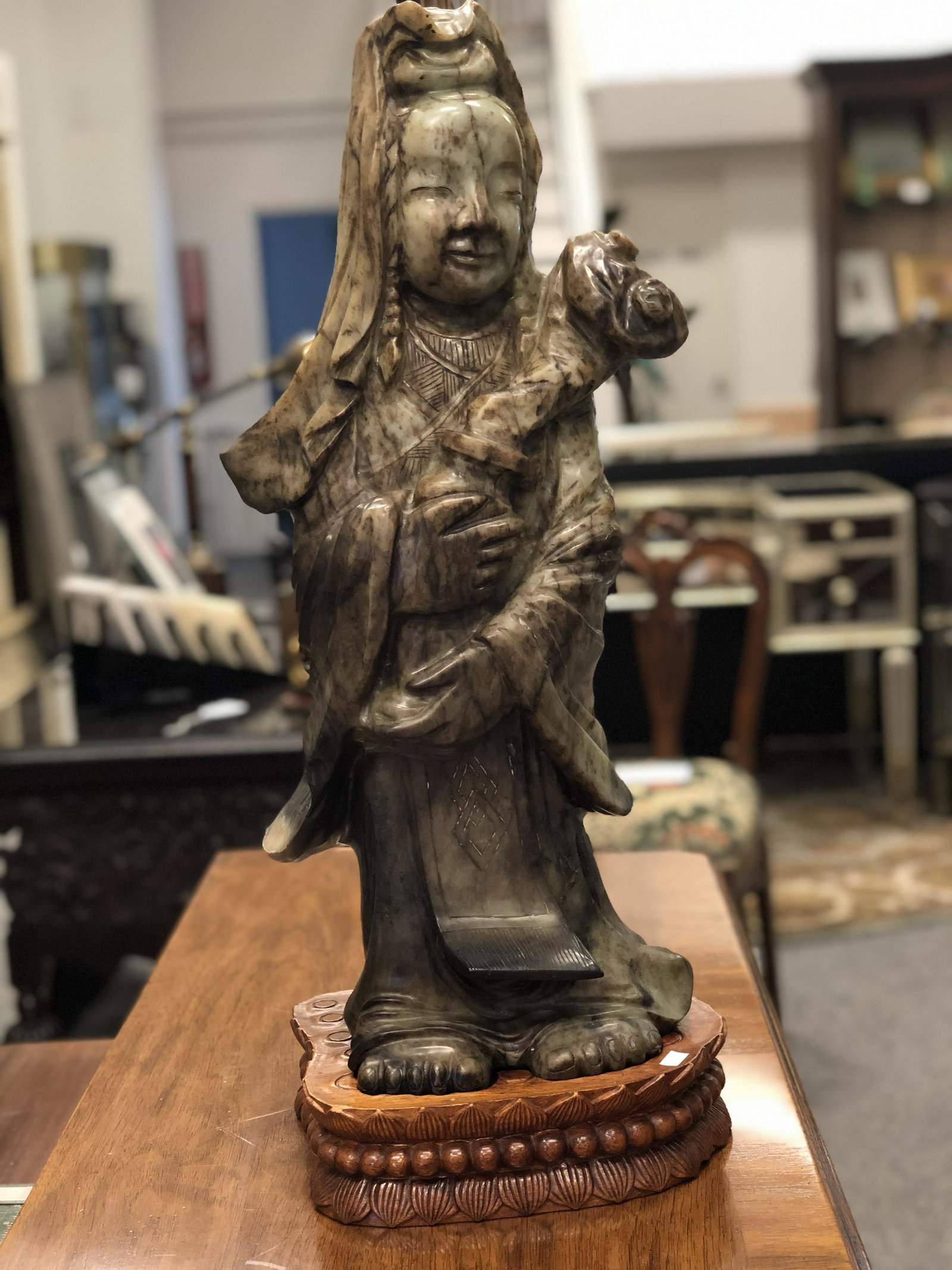 LARGE CARVED JADE QUAN YIN SCULPTURE 24": Very large Chinese carved jade Quan Yin sculpture. Measures: 24" x 8 12" x 8 1/2" and sets on a carved wood base, which measures: 10.5" x 9" x2". Condition: Good. base has a few dings.