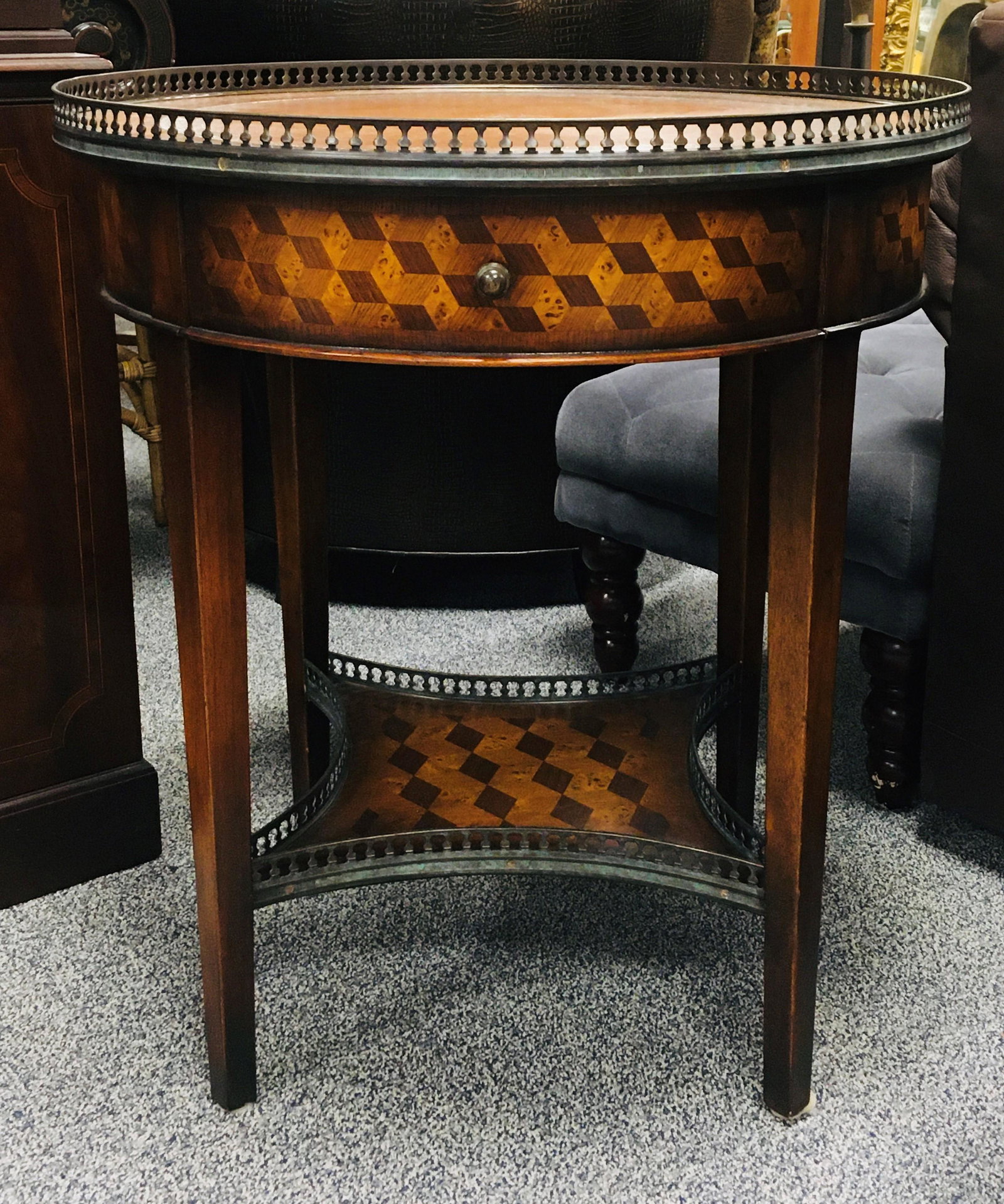 VINTAGE PARQUETRY INLAID ROUND SIDE TABLE: Vintage parquetry inlaid round side table, leather top. Two tiers, with bronze gallery on each one. Measures 29.25" tall x 26" diameter. Condition: good, may show minor signs of normal use, see images