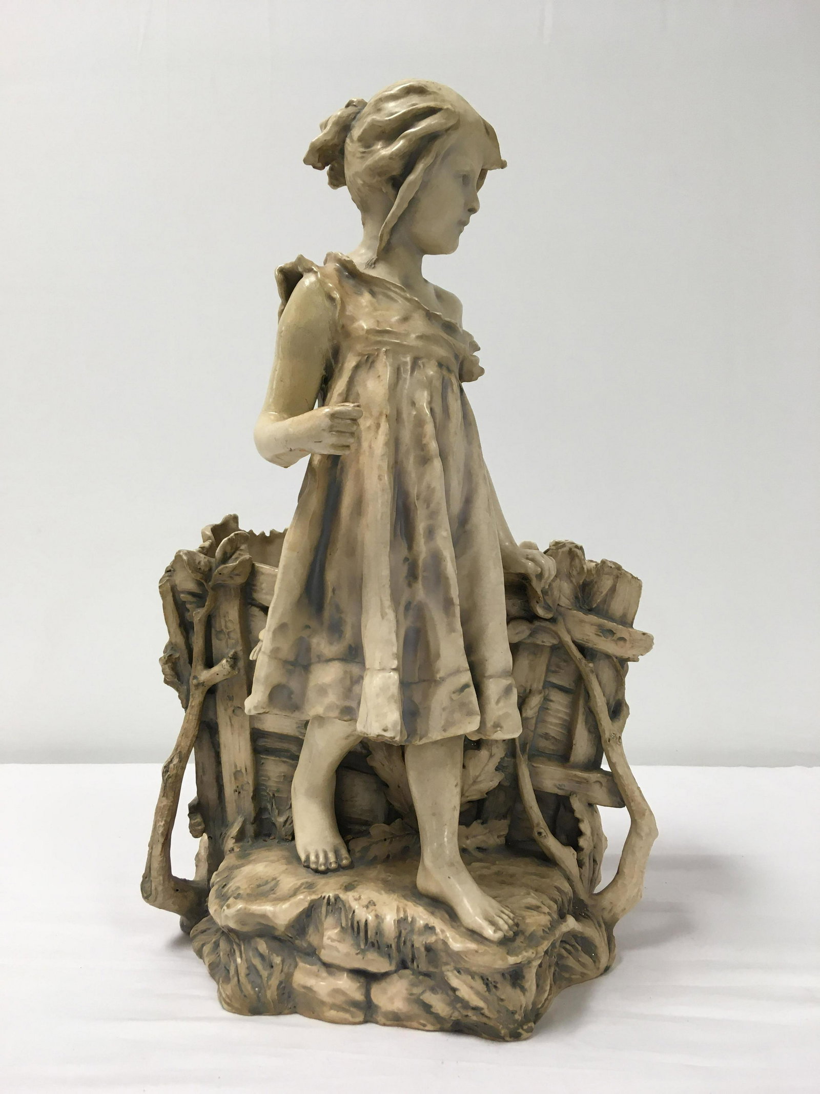 AMPHORA RIESSNER STELLMACHER & KESSEL JARDINERE: Large antique Riessner Stellmacher & Kessel porcelain jardinere in the form of a young girl. 20" tall x 12" wide. Incised in m,ultiple areas on base. Condition: older professional restoration to arm, 