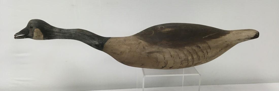 VINTAGE CARVED AND PAINTED WOOD CANADA GOOSE DECOY: Vintage carved and painted wood Canada Goose decoy. Measures 35" long x 7" tall at the head. Signed illegibly and dated 1983. Condition: minor signs of wear and age, slight damage to tip of beak, see