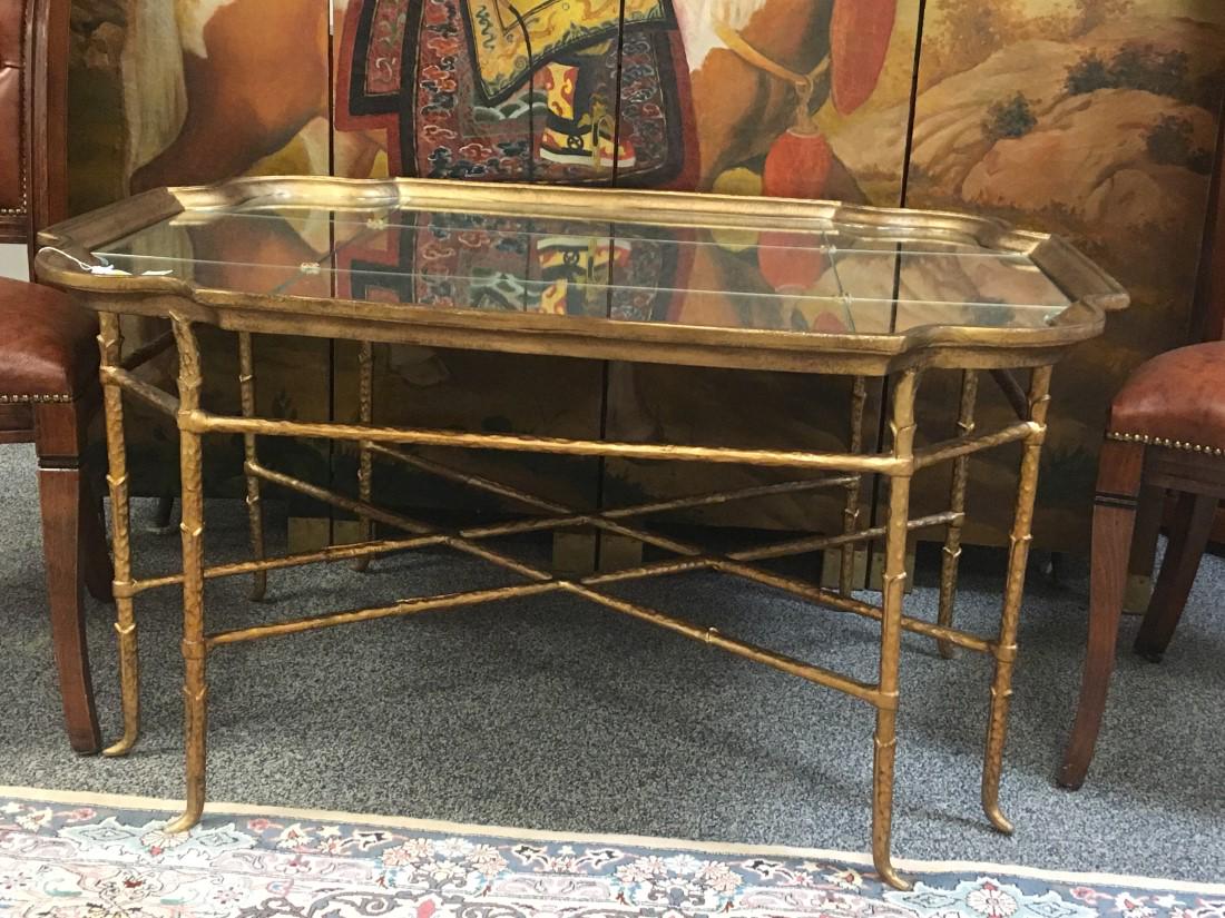 CONTEMPORARY MIRRORED COFFEE TABLE: Contemporary mirrored finish coffee table with a gold toned metal frame. Measures a total of 23.25" tall x 45" long x 34.5" wide. Condition: a few small scratches to mirrored surface, see images. Weig