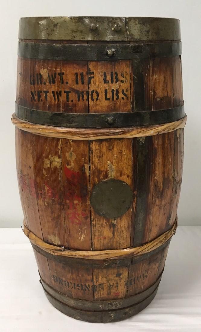 ANTIQUE WOOD & IRON BARREL: Antique wood and iron grain barrel. Marked "Made in Hong Kong", "RWC Honolulu". Metal strapped wood barrel, measures 24" tall x approx. 14" diameter. Condition: old repair to midsection, see images. W