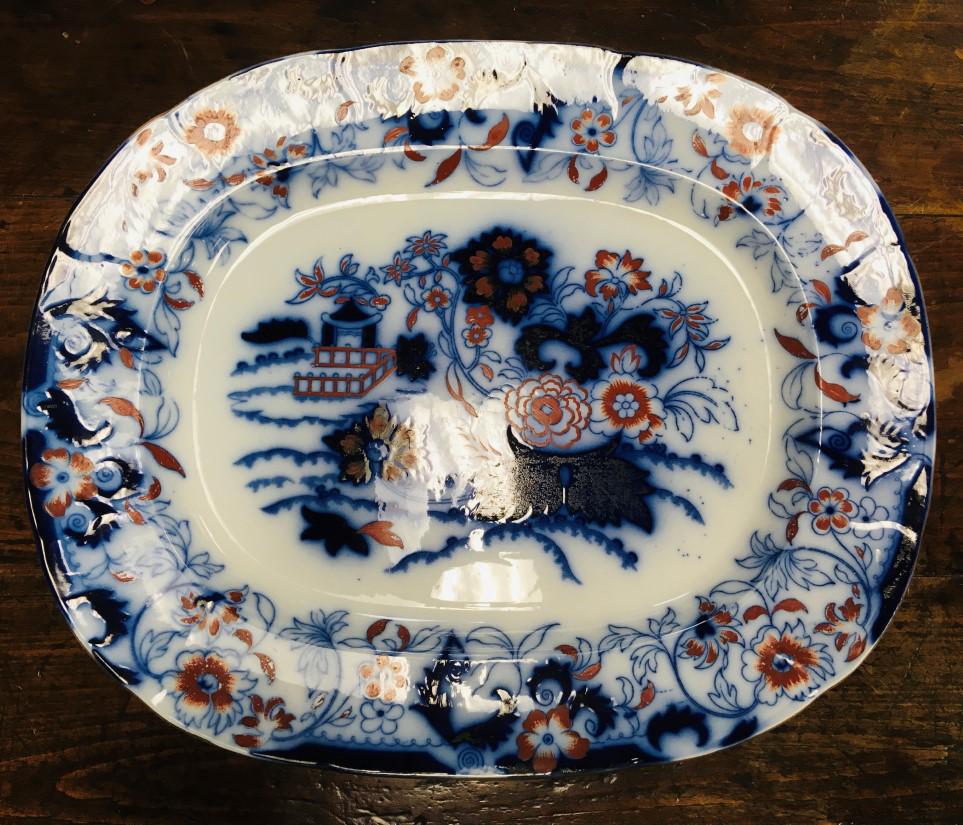 LARGE 19TH C FLOW BLUE PAGODA IMARI TYPE PLATTER: An early 19th century pagoda / Imari / Gaudy style flow blue ironstone platter. Unsigned, marked on base with a few various factory marks. Measures 21.25" long x 17.5" wide. Condition: good, no chips 