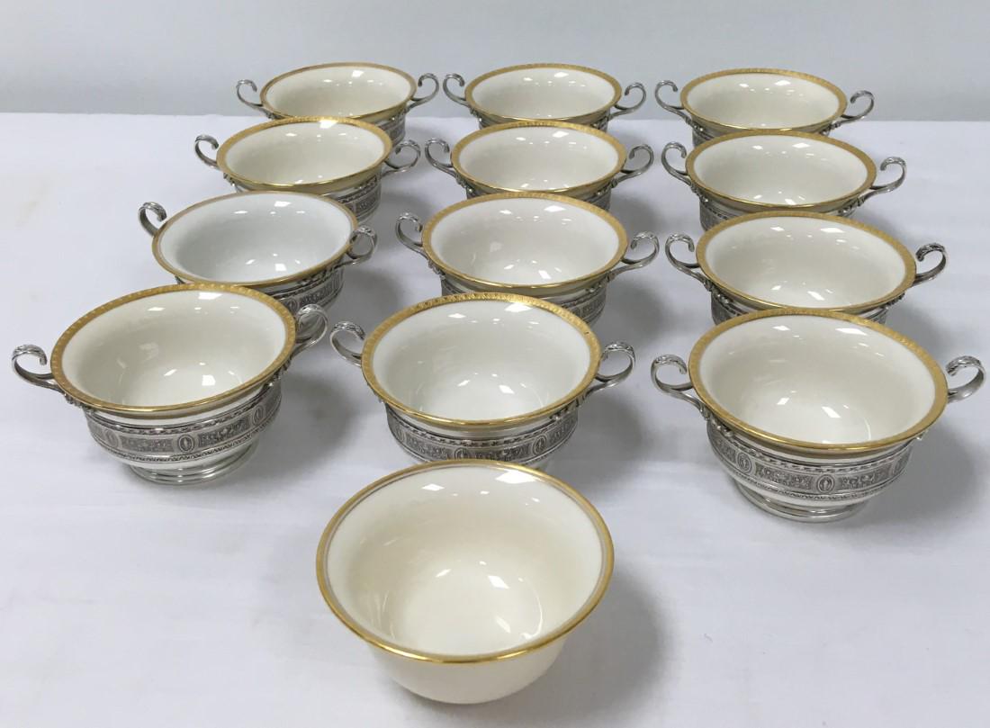 TWELVE PORCELAIN & STERLING SILVER BOUILLON CUPS: Lot of twelve Lenox porcelain bouillon cups with International sterling silver holders. Each one measures a total of 5.85" handle to handle, or 4.25" diameter (porcelain only). Includes two with a Len