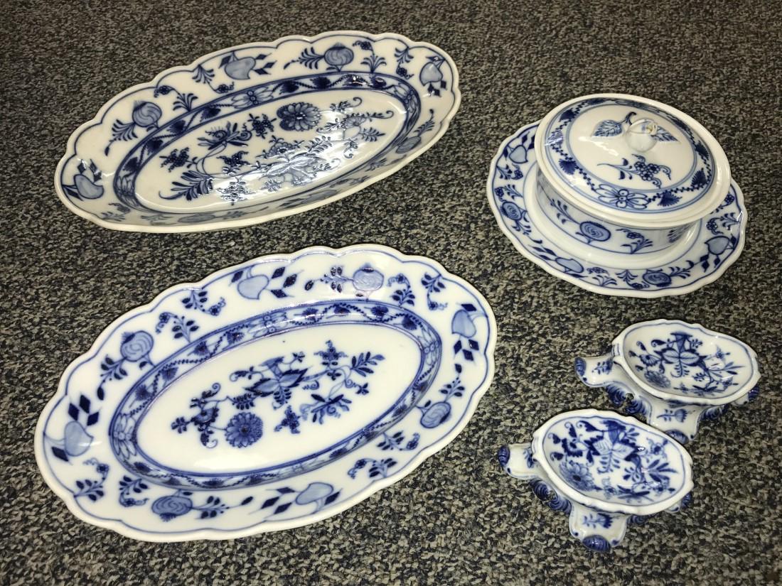 FIVE PIECES MEISSEN BLUE ONION PORCELAIN WARE: Lot of five pieces of Meissen blue onion porcelain ware. Includes a covered butter dish, two salt cellars with crossed swords mark, a 12" long oval tray and a 10" long oval dish. Condition: loss to on