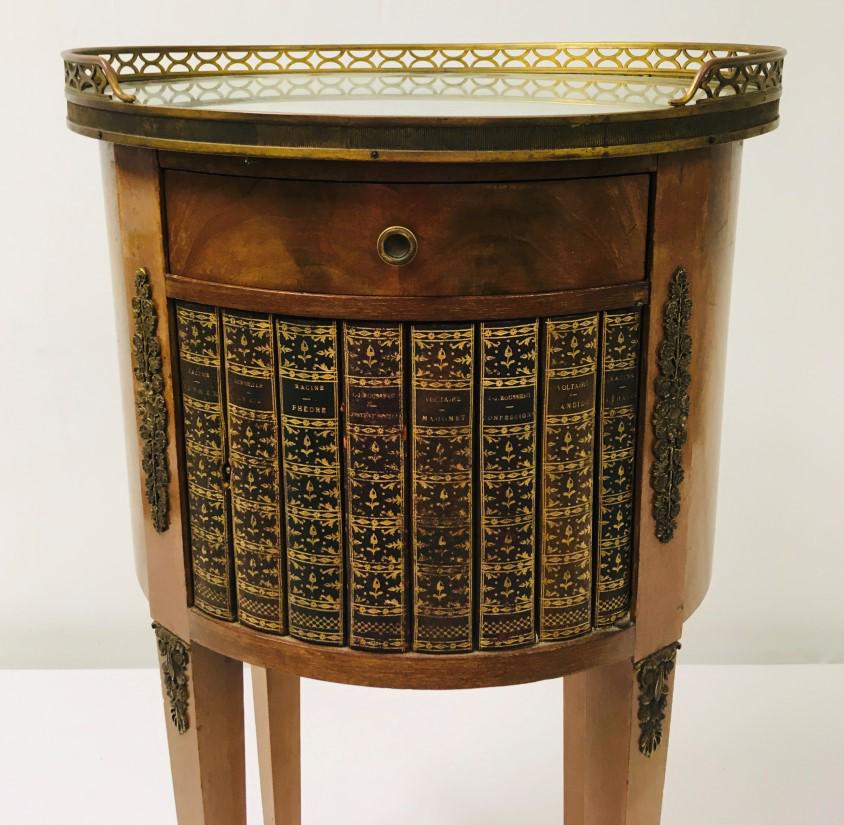 FRENCH LOUIS XVI STYLE FAUX BOOK SIDE TABLE: French Louis XVI style faux book side table with a pierced bronze gallery and mirrored top. Bronze paw feet. Measures a total of 30" tall x 16.5" wide and 13.5" deep. Condition: does not include key, 