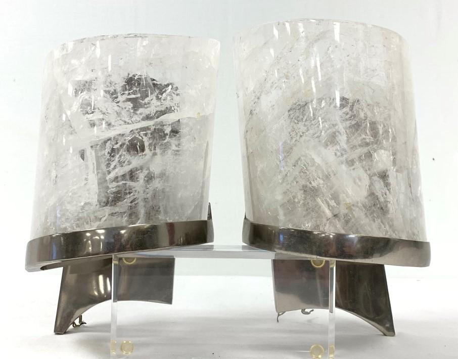 PAIR MODERN ROCK CRYSTAL & CHROME WALL SCONCES: Pair of modern carved natural rock crystal wall sconces with chrome finished frames. Each one measures a total of 12" tall x 7" wide and 7" deep. Condition: minor signs of use and age to chrome finish