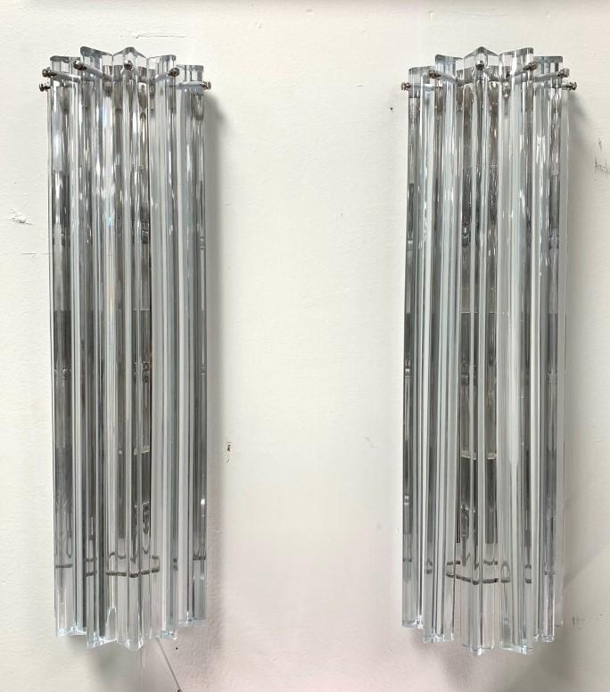 PAIR MODERN CRYSTAL & CHROME WALL SCONCES: Pair of modern crystal and chrome wall sconces. Each one features six long triangular shaped crystal bars hanging over three bulbs. Condition: minor signs of wear and age to chrome finish, small flake