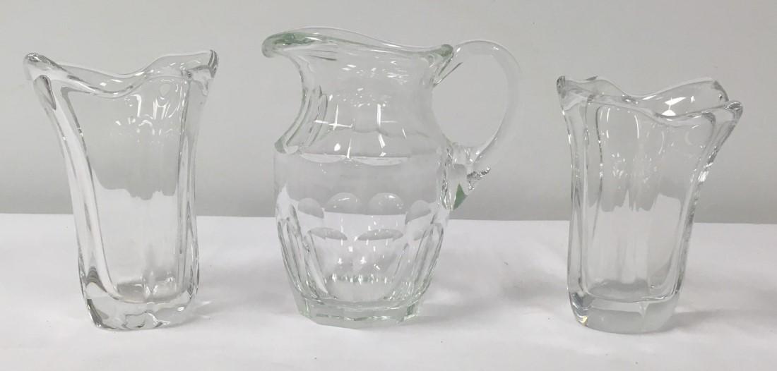 PAIR OF DAUM GLASS VASES & MOSER PITCHER: Pair of Daum Nancy French art glass vases: freeform design in clear glass. Both signed on isde of base "Daum France". Condition: good, no chips or cracks, . Moser cut crystal pitcher measuring 8.25" t