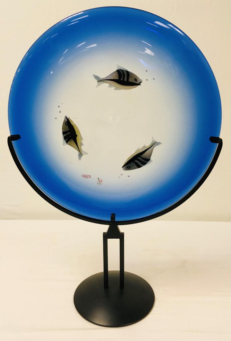 LARGE GLASS SCULPTURE: RAFFAELI FOR OGGETTI MURANO: Large art glass sculptural plate by Rffaeli for Oggetti Murano. Includes black metal stand. Plate is engraved with signature and and marked with sticker labels. Plate measures 18.75" diameter and scul