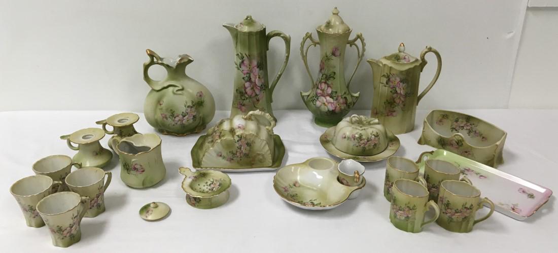 COLLECTION NIPPON DOGWOOD FLORAL PORCELAIN WARE: Collection of assorted Nippon "Dogwood" floral porcelain ware. Includes 20 total pieces. Size reference: tallest pitcher is 12" tall. Long tray measures 10.5" long. Condition: repair to one handle on 
