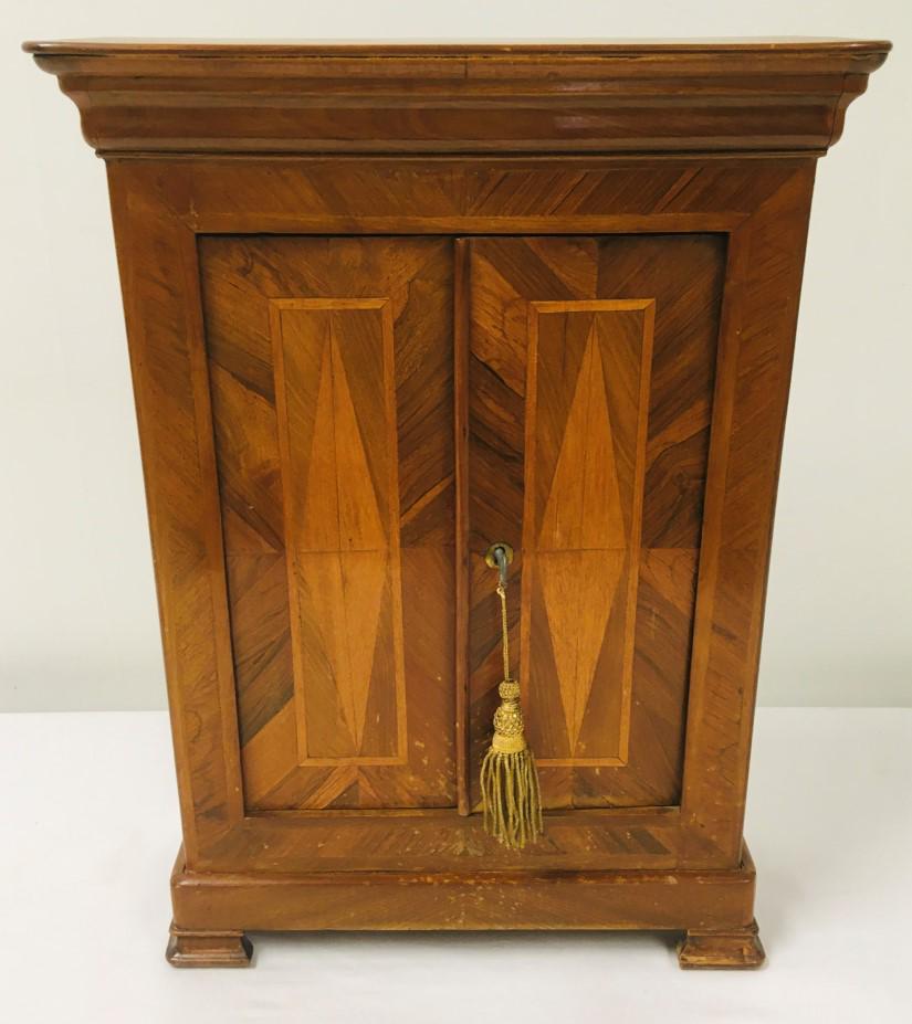ANTIQUE BIEDERMEIER STYLE INLAID MINIATURE CABINET: Antique Biedermeier style parquetry inlaid miniature cabinet measuring 21" tall x 15.5" wide x 6" deep. Includes damaged key. Condition: damage to finish on the front, minor loss and repair to veneer,