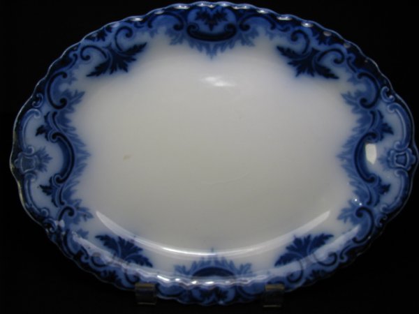 GRINDLEY FLOW BLUE SMALL PLATTER: Clifton pattern.: FLOW BLUE SMALL PLATTER: Clifton pattern. W.H. Grindley & Company, Tunstall, Staffordshire, England, circa 1891-1914. Floral sprays. Measures 11" long. Blue printed mark: globe and ship surrounded by