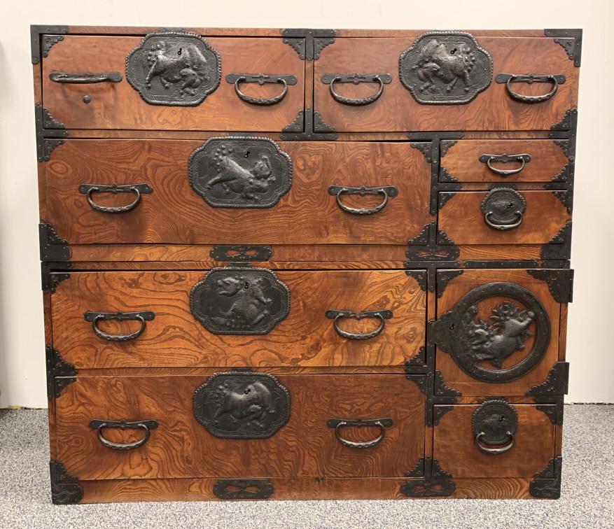 JAPANESE MEIJI ZELKOVA WOOD SENDAI TANSU CHEST: A Japanese Meiji Period Zelkova, Chestnut and cedar wood Sendai Tansu chest. Two main parts, both sections with pull out handles for carrying. Intricate toreutics on the lock plates and hardware depic