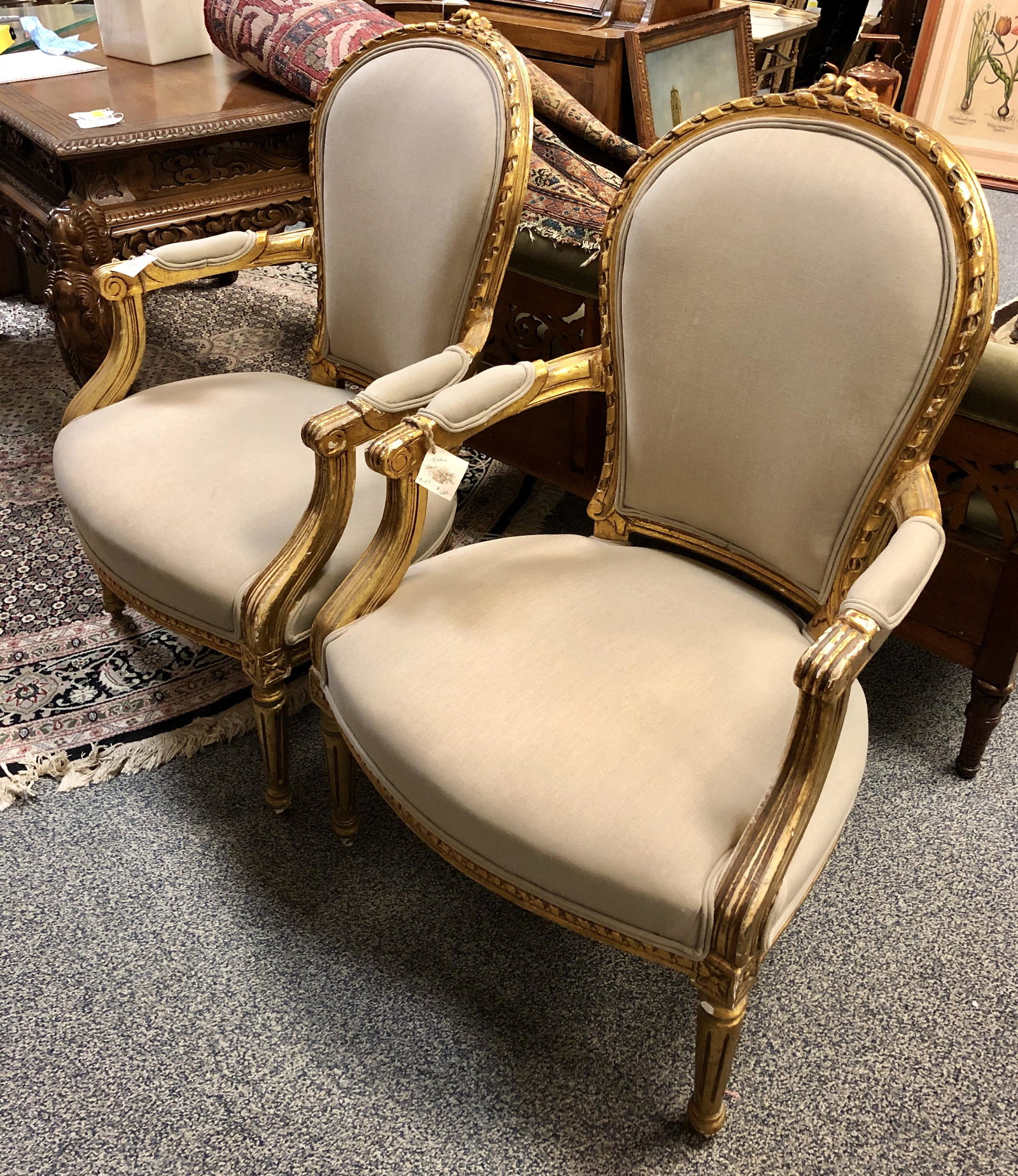 PAIR ANTIQUE FRENCH GILTWOOD ARMCHAIRS: Pair of antique French giltwood armchairs, each measuring 38" tall x 23.5" wide and 22" deep. Seat height 16.5". Grey linen upholstery, with medallion back in cream damask pattern. Condition: newly re