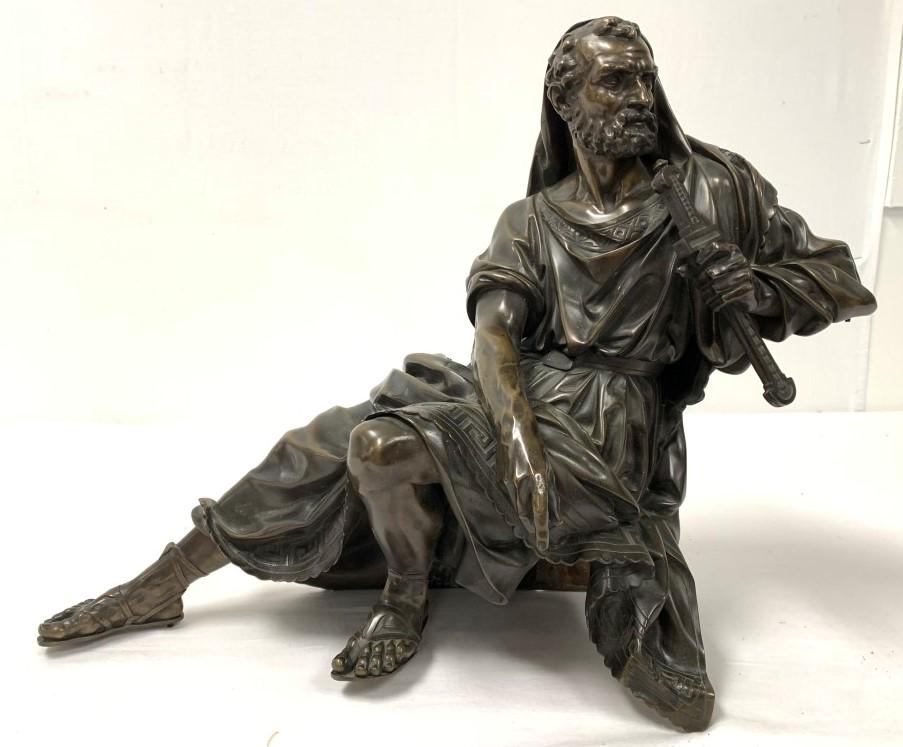 ANTIQUE FRENCH BRONZE SCULPTURE OF A BEARDED MAN: Antique 19th century French bronze sculpture of a reclining bearded man holding a dagger. Unsigned, unmarked. This piece came off a large clock, one foot has a pin on the bottom where it previously mo