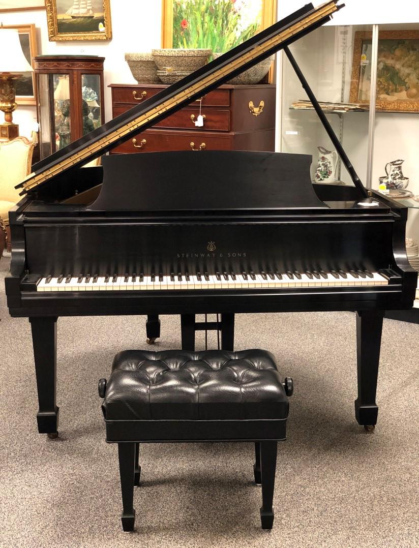 STEINWAY MODEL M MEDIUM GRAND PIANO 1969: Steinway model M Medium Grand Piano with bench. Serial number 412008, dates to 1969. Black lacquer finish. Condition: good and working, minor signs of normal use to finish, see images. Measures a tota