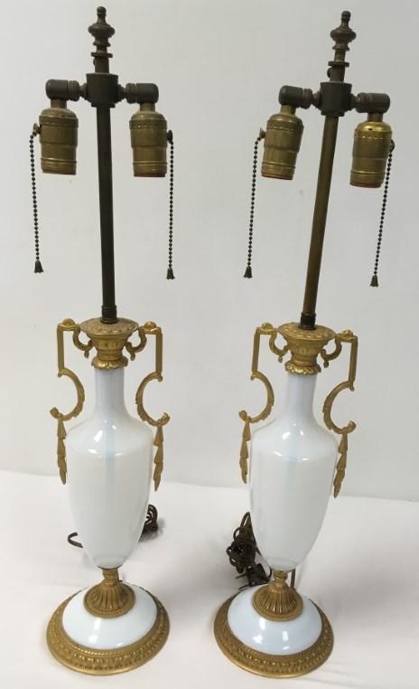 PR ANTIQUE FRENCH OPALINE GLASS ORMOLU TABLE LAMPS: Pair of antique French opaline glass and ormolu table lamps. Urn form, each measuring a total of 27.25" tall with a 5.75" base diameter. Condition: one lamp has a small repair to the edge of the glass