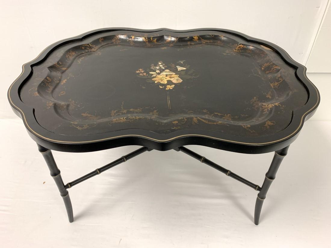 ANTIQUE VICTORIAN PAINTED BLACK LACQUER TRAY TABLE: Antique Victorian English painted and mother of pearl inlaid black lacquer tray table. Frame later made to fit the tray. Together, the table measures 33.5" long x 26" wide and 19" tall. Condition: tra