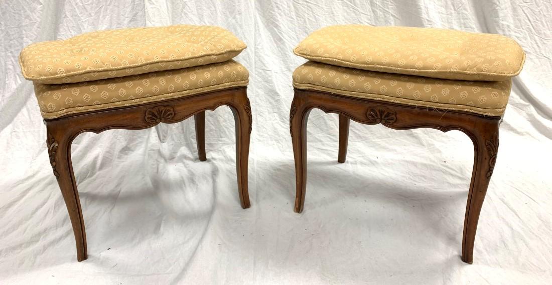 PAIR FRENCH CARVED CHERRYWOOD FOOTSTOOLS: Pair of vintage French carved cherrywood upholstered footstools, each measuring 18" tall x 19.5" long and 15" deep. Condition: minor nicks and scuffs to wood finish, minor signs of wear and use to uph