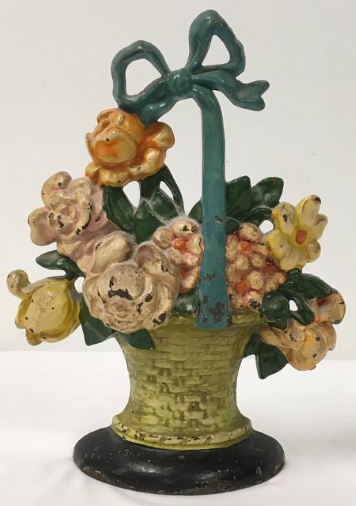 ANTIQUE CAST IRON FLOWER BASKET DOORSTOP: Antique painted cast iron flower basket doorstop measuring 10.5" tall. Condition: minor signs of normal age, some chips to paint, see images. Weight: 6.1 lbs.