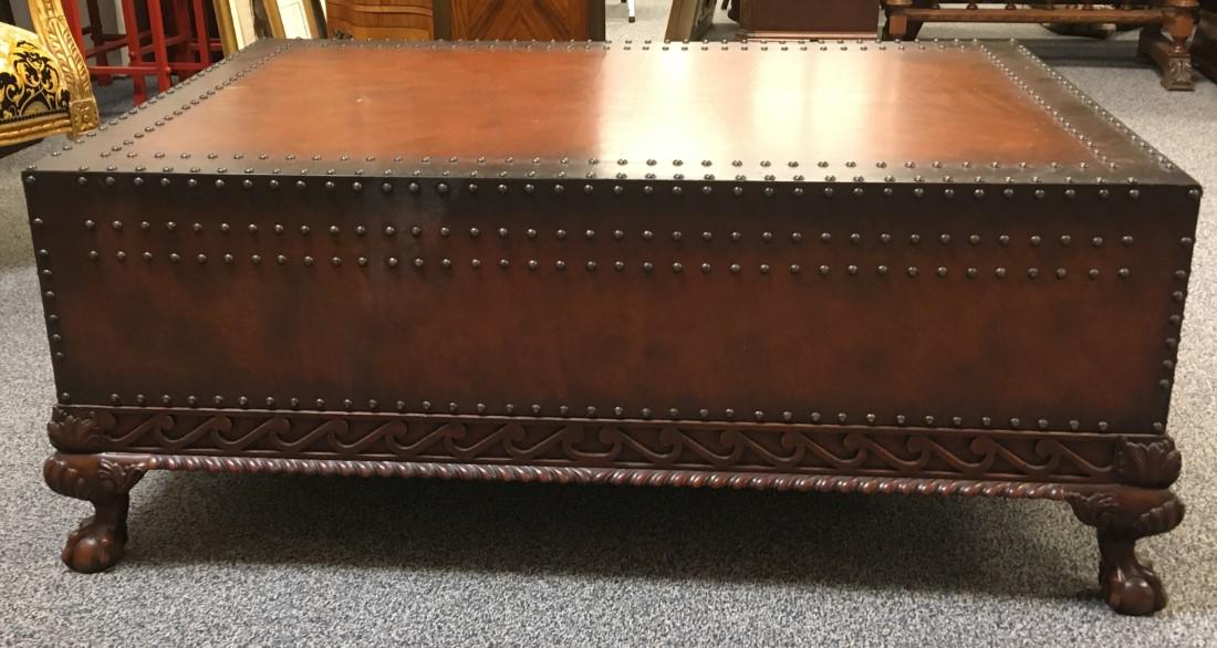 LARGE RALPH LAUREN LEATHER TOP COCKTAIL TABLE: Large rectangular Ralph Lauren leather topped cocktail table with nailhead trim. Measures 19.5" tall x 50" long and 34" wide. Two drawers- one on each end. Ball and claw feet with carved lower edge an