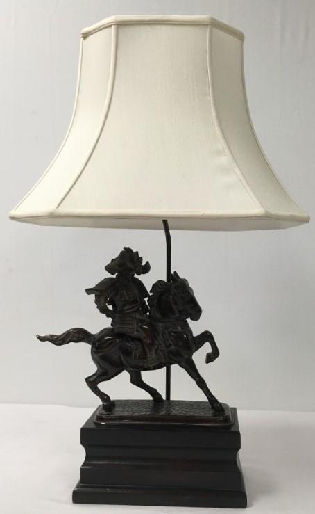 LARGE FREDERICK COOPER CAST BRONZE TABLE LAMP: Frederick Cooper table lamp in the form of a Japanese warrior on horseback. Includes white fabric shade. Lamp is currently working, shade has a few small tears to inner liner, scuffs to wooden base, s