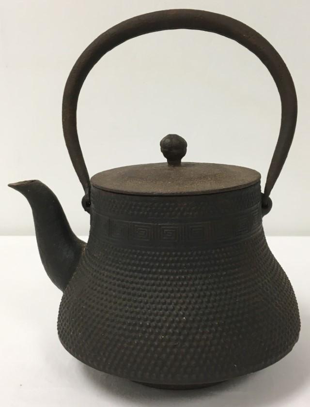 ANTIQUE JAPANESE MEIJI TETSUBIN CAST IRON TEAPOT: Antique Japanese Meiji tetsubin or cast iron teapot. Measures a total of 12" tall with handle up x 9.5" long. Marked near spout. Condition: expected signs of age and wear, small loss near base on back